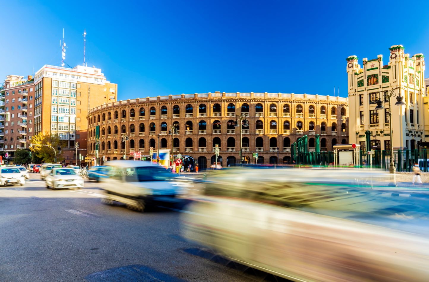 Car traffic passing by the bullring in Calle de Xàtiva, Valencia