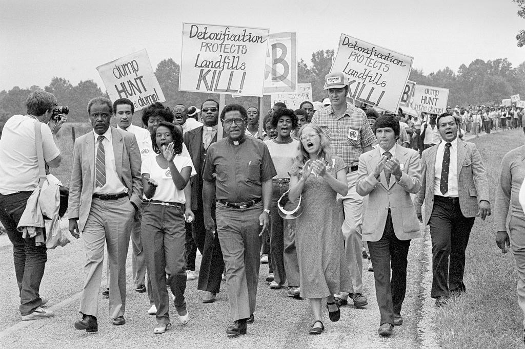 Protesters marching against a PCB landfill in Afton, Warren County, North Carolina, led by Reverend Leon White (second from left), Reverend Joseph Lowery (center), and Ken Ferruccio (second from right). 1982. Getty Images, Bettmann Archive. Photograph: Otto Ludwig Bettmann