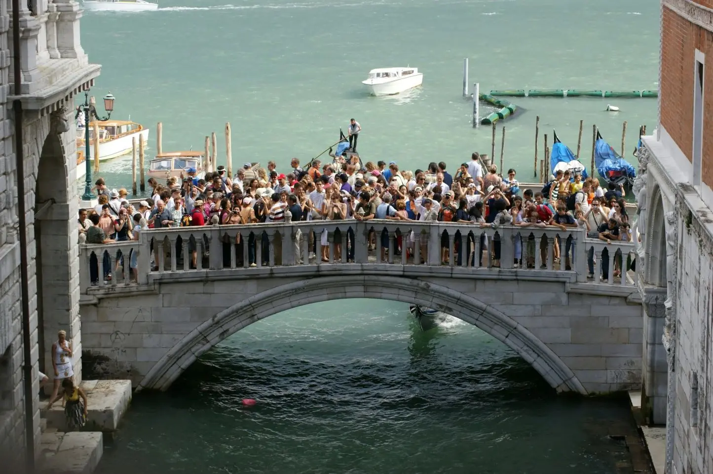 Un vecchio ponte affollato di turisti a causa dell'overtourism a Venezia